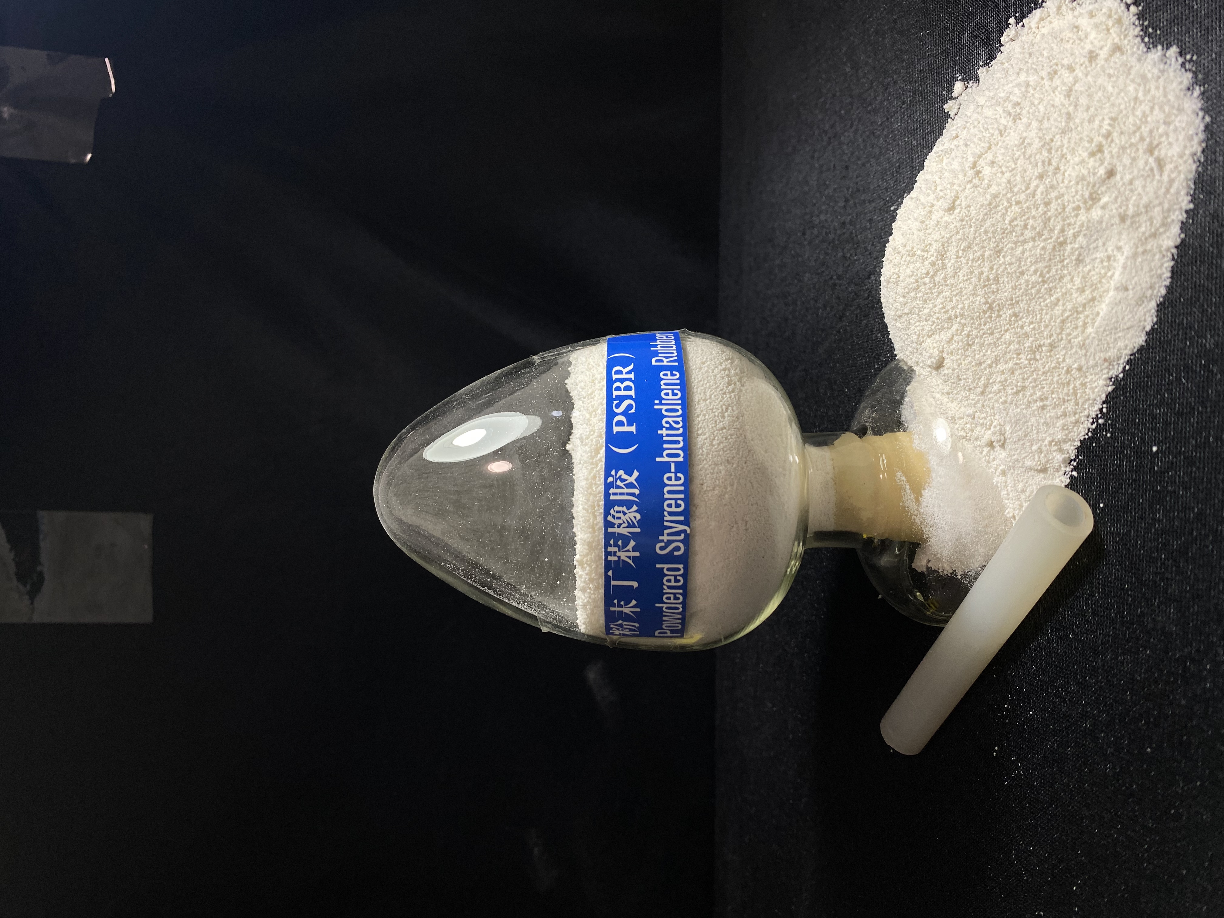 psbr-rubber-powder-sample-flask-display-with-spilled-powder